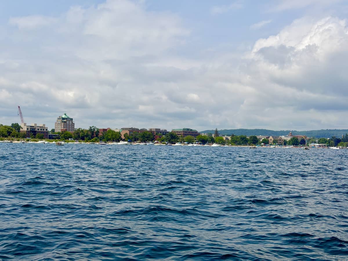 Grand Traverse Bay looking toward the downtown Traverse City, Michigan waterfront, with boats moored along the shoreline